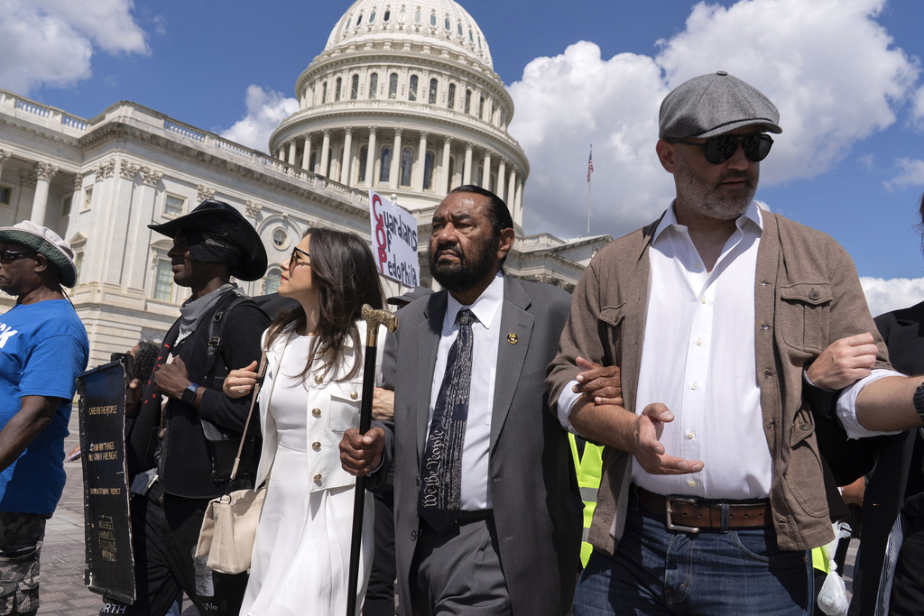 Rep. Al Green, D-Texas, center, marches with demonstrators protesting against President Donald Trump's use of federal law enforcement and National Guard troops in Washington during a protest at the U.S. Capitol, Tuesday, Sept. 2, 2025. (AP Photo/Jose Luis Magana)