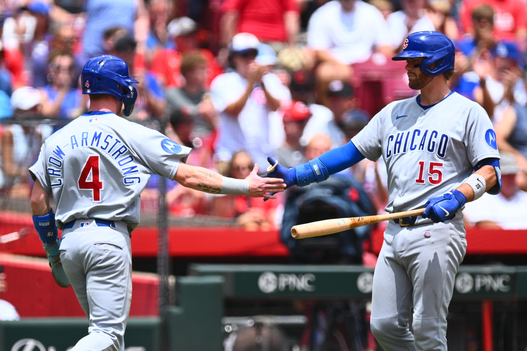 Chicago Cubs' Pete Crow-Armstrong, left, celebrates with Carson Kelly, right, after scoring on a double hit by Alex Bregman during the first inning of a baseball game against the Cincinnati Reds in Cincinnati, Sunday, July 12, 2026. (AP Photo/Ben Jackson)