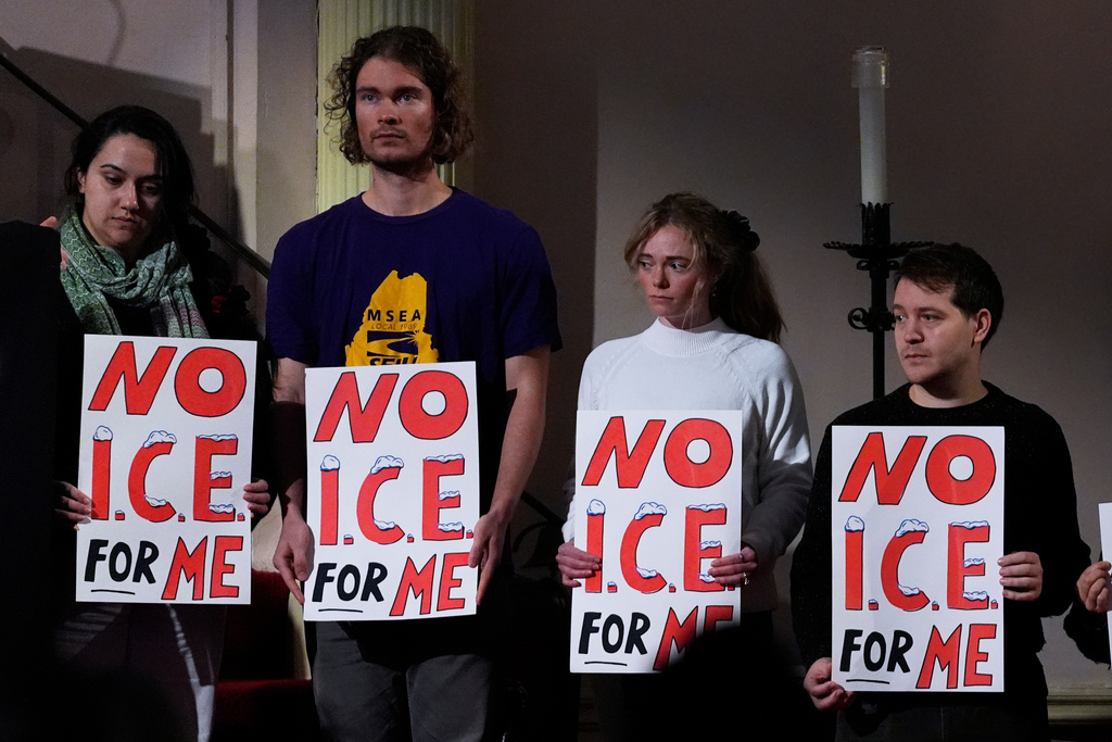 Attendees hold signs at a news conference held by public officials and faith leaders calling for the abolishment of the U.S. Immigrant and Customs Enforcement, Friday, Jan. 30, 2026, in Portland, Maine. (AP Photo/Robert F. Bukaty)