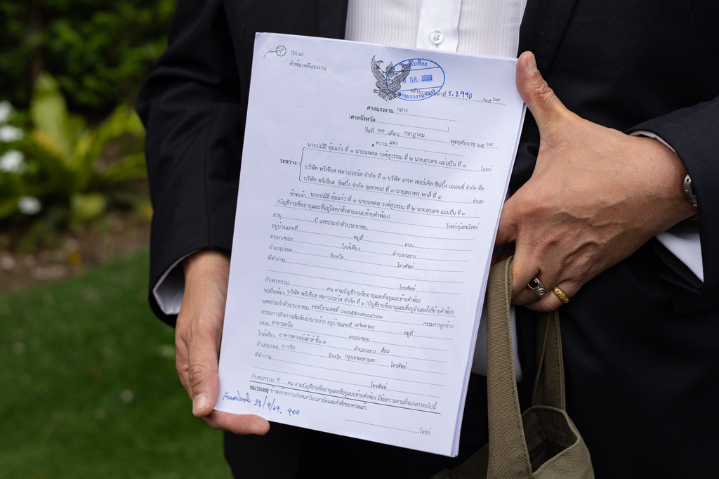 A Thai lawyer holds legal documents for a case filed by former sailors of the Thailand-flagged ship, the Mayuree Naree, outside the Central Labour Court in Bangkok, Thailand on Friday, July 10, 2026. (AP Photo/Anton L. Delgado)