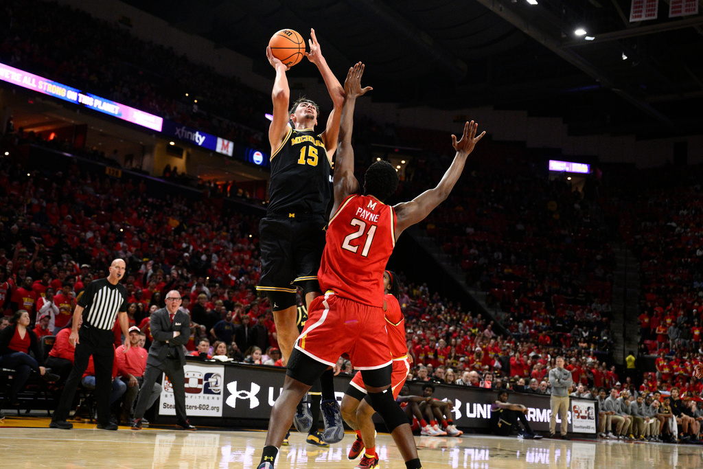 Michigan center Aday Mara (15) goes to the basket against Maryland forward Pharrel Payne (21) during the first half of an NCAA college basketball game, Saturday, Dec. 13, 2025, in College Park, Md. (AP Photo/Nick Wass)