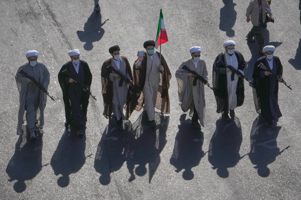 Shiite clerics carrying rifles march during the state-organized "Janfada," or "Sacrifice for Iran," military-style parade at Revolution Square in Tehran, Iran, Friday, Sept. 18, 2026. (AP Photo/Vahid Salemi)