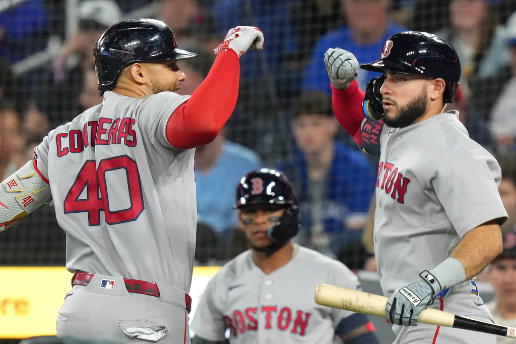 Boston Red Sox's Willson Contreras (40) celebrates with Wilyer Abreu (52) after hitting a home run off in the first inning of a baseball game against the Toronto Blue Jays in Toronto, Wednesday, April 29, 2026. (Chris Young/The Canadian Press via AP)