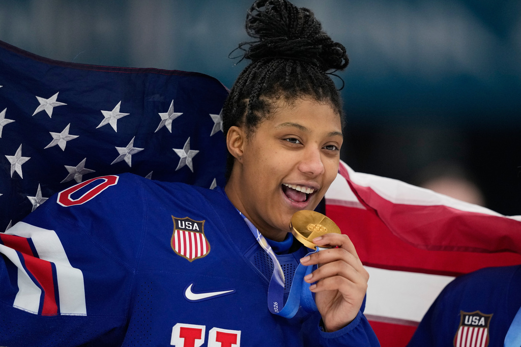 FILE - United States' Laila Edwards (10) poses after the United States' women's ice hockey team was presented with the gold medals at the 2026 Winter Olympics, in Milan, Italy, Feb. 19, 2026. (AP Photo/Petr David Josek, File)