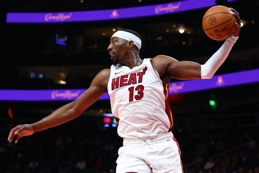 Miami Heat center Bam Adebayo (13) grabs a rebound during the first half of an NBA basketball game against the Atlanta Hawks, Friday, Feb. 20, 2026, in Atlanta. (AP Photo/Colin Hubbard)