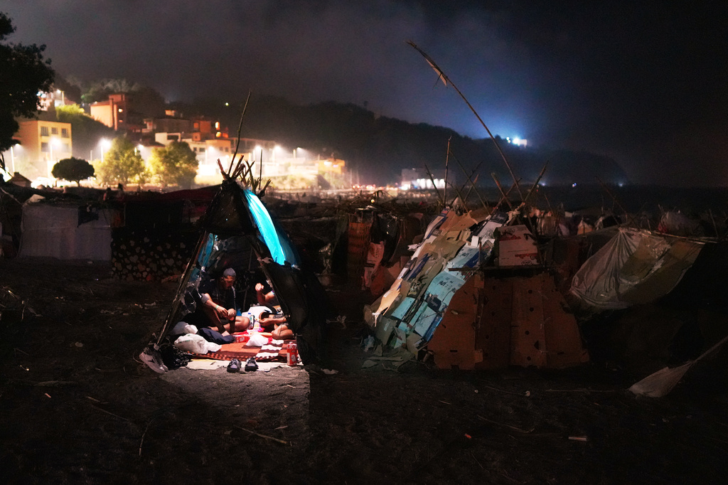 Migrants sit inside their tents at El Trampolín beach in the Spanish exclave of Ceuta, Wednesday, Sept. 2, 2026. (AP Photo/Francis González)