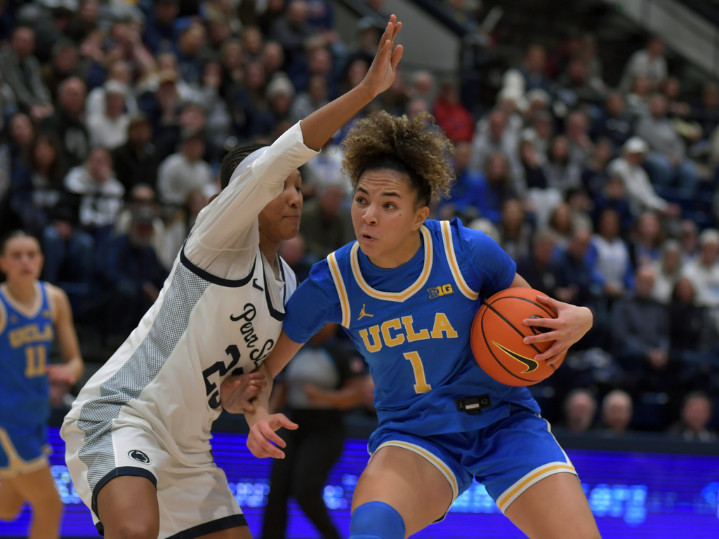 UCLA's Kiki Rice (1) pulls up to shoot on Penn State's Kiyomi McMiller, left, during the first half of an NCAA college basketball game, Wednesday, Dec. 31, 2025, in State College, Pa. (AP Photo/Gary M. Baranec)