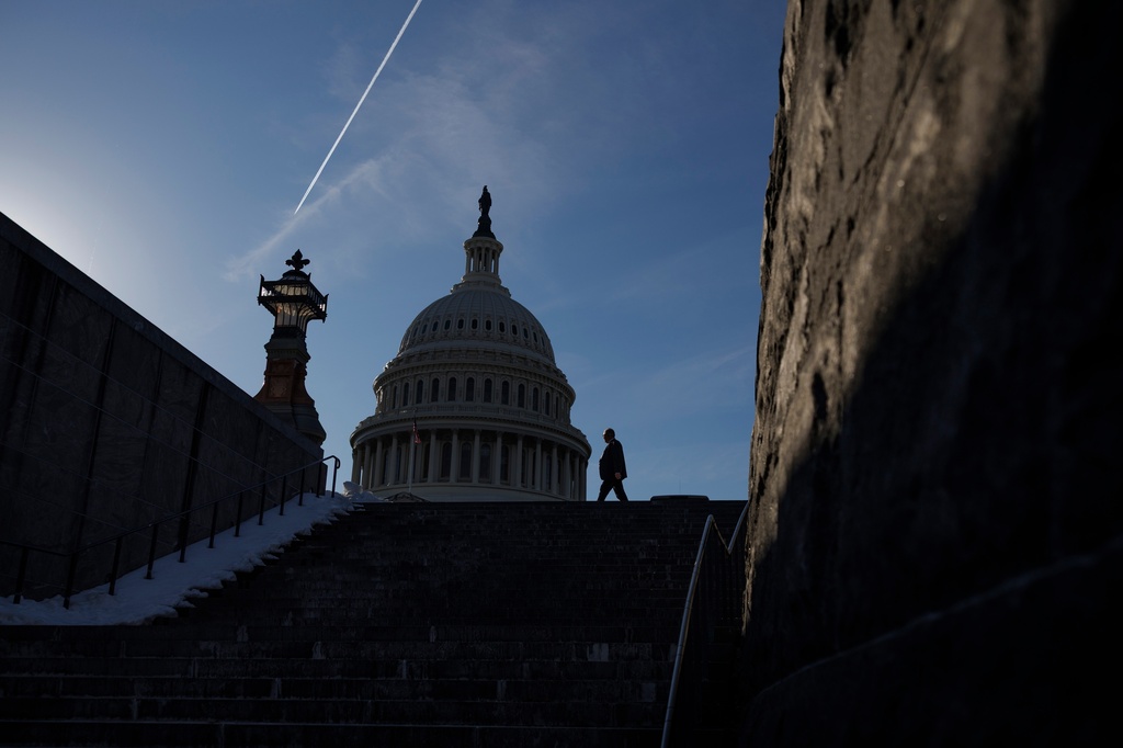 A visitor walks through the East Front Plaza outside the Capitol, Tuesday, Feb. 10, 2026, in Washington. (AP Photo/Tom Brenner)