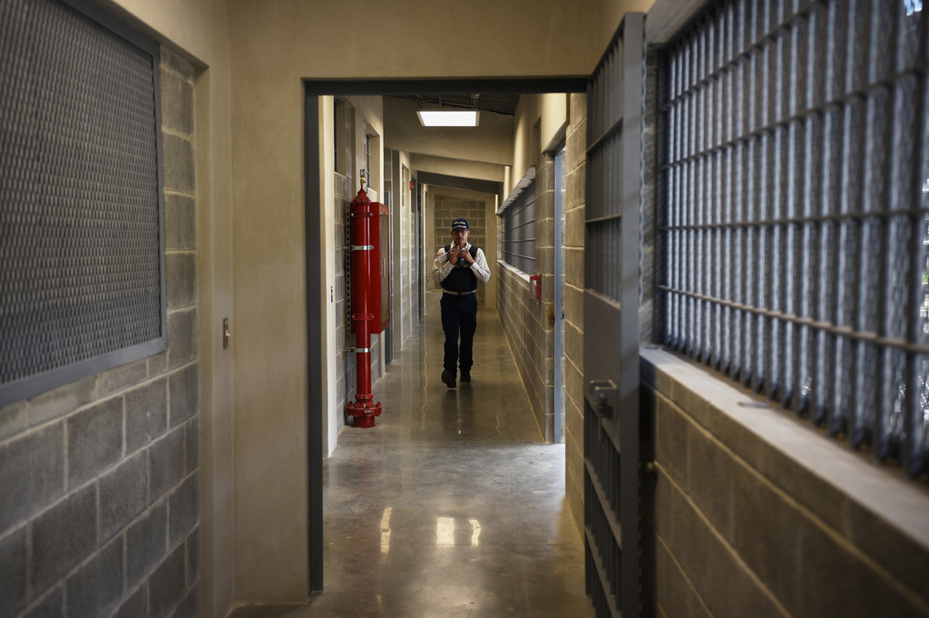 A police officer walks through a hallway during a press tour of a new high-security prison in Alajuela, Costa Rica, Wednesday, Oct. 14, 2026. (AP Photo/Jose Diaz)