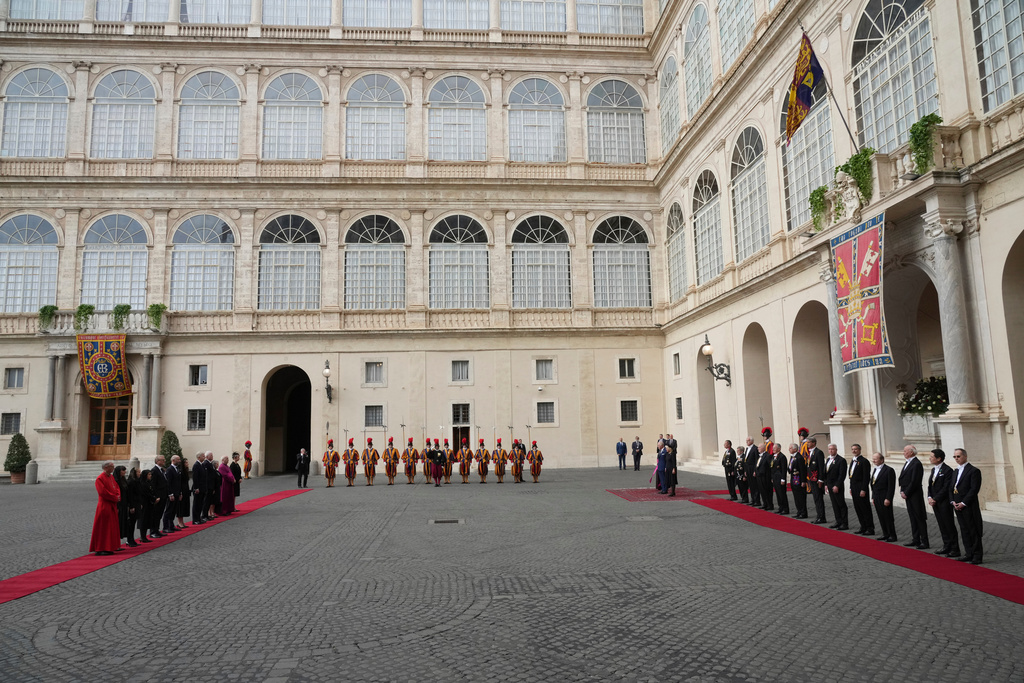 Britain's King Charles III and Queen Camilla listen national anthems in the St. Damasus Courtyard at the Vatican for a state visit, where they will meet with Pope Leo XIV and pray with him in the Sistine Chapel, Thursday, Oct. 23, 2025. (AP Photo/Andrew Medichini)