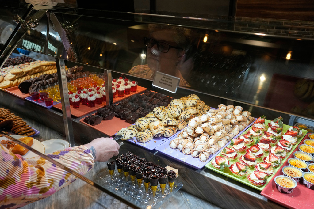 FILE - A person picks out dessert at the A.Y.C.E Buffet in the Palms resort-casino Wednesday, Jan. 28, 2026, in Las Vegas. (AP Photo/John Locher, File)