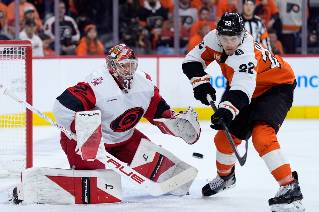 Carolina Hurricanes' Frederik Andersen, left, blocks a shot as Philadelphia Flyers' Christian Dvorak reaches in during the second period of Game 3 in the second round of the NHL hockey Stanley Cup playoffs, Thursday, May 7, 2026, in Philadelphia. (AP Photo/Matt Slocum)