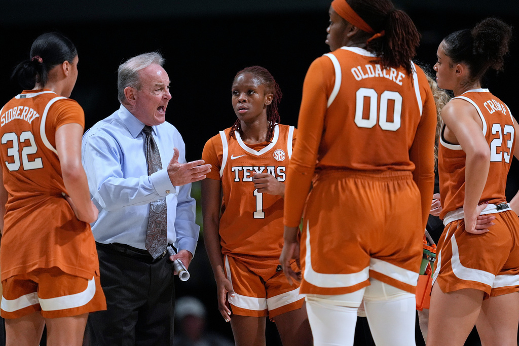 Texas head coach Vic Schaefer, second from left, yells at his players during the second half of an NCAA college basketball game against Vanderbilt, Thursday, Feb. 12, 2026, in Nashville, Tenn. (AP Photo/George Walker IV)