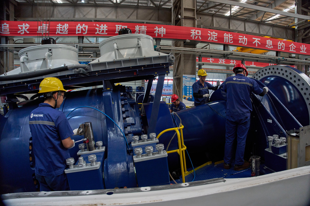 Workers labor on wind turbines at the Mingyang North Smart Energy factory in Baotou in northern China's Inner Mongolia province on Saturday, June 13, 2026. (AP Photo/Ng Han Guan)