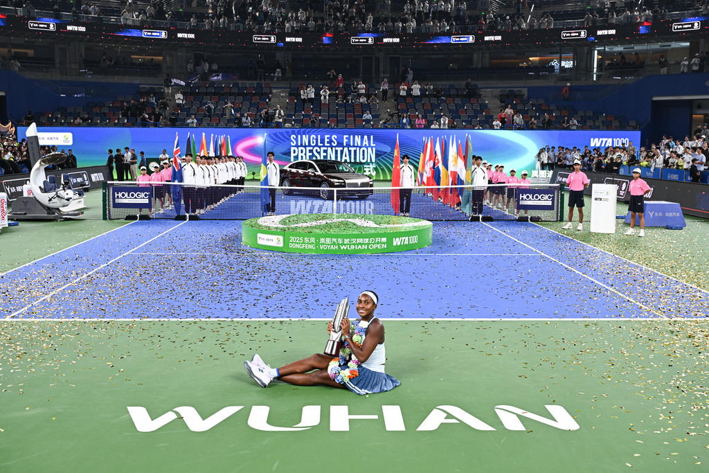 Coco Gauff of the United States celebrates with her trophy after defeating her compatriot Jessica Pegula in the women's singles final at the WTA Wuhan Open in Wuhan in central China's Hubei province Sunday, Oct. 12, 2025. (Chinatopix Via AP) CHINA OUT