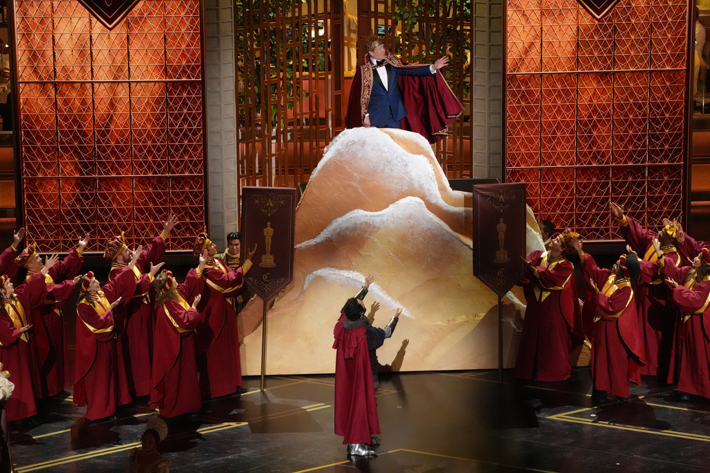 Host Conan O'Brien, top, and Josh Groban perform during the Oscars on Sunday, March 15, 2026, at the Dolby Theatre in Los Angeles. (AP Photo/Chris Pizzello)