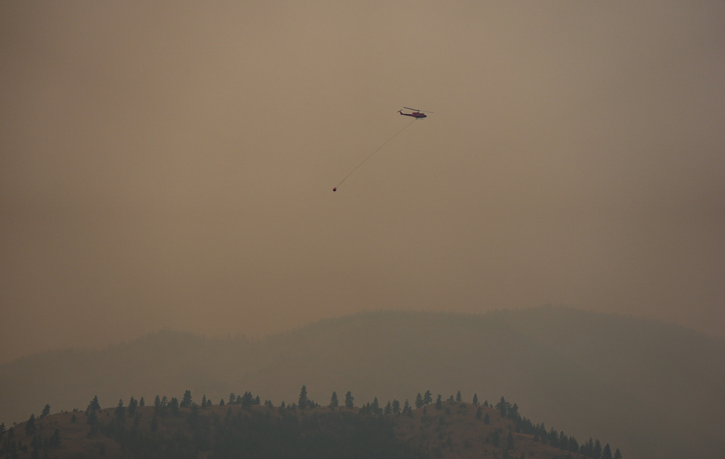 A helicopter being used to battle the Bald Range wildfire takes off from the Penticton Regional Airport, in Penticton, British Columbia, Monday, Aug. 10, 2026. (Darryl Dyck/The Canadian Press via AP)