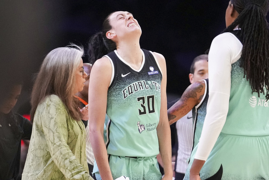 New York Liberty forward Breanna Stewart (30) grimaces after getting fouled by the Phoenix Mercury during the second half of Game 1 during the first round of the WNBA basketball playoffs Sunday, Sept. 14, 2025, in Phoenix. (AP Photo/Darryl Webb)