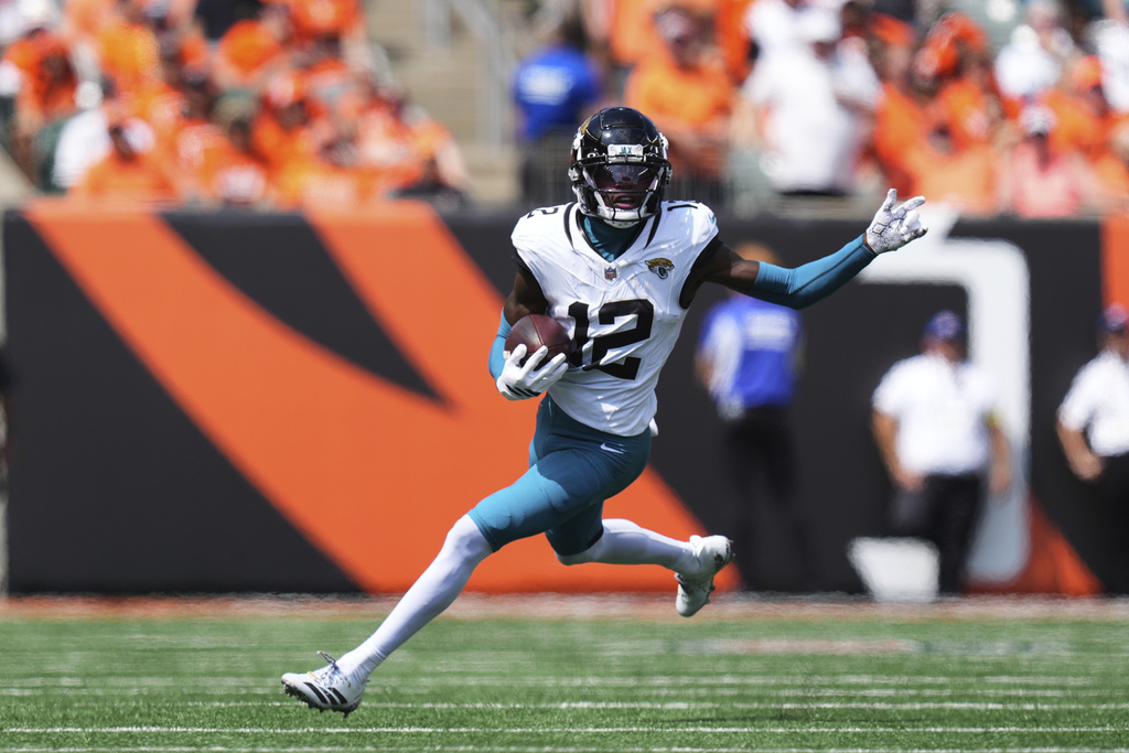 Jacksonville Jaguars wide receiver Travis Hunter (12) runs after a catch first half of an NFL football game against the Cincinnati Bengals, Sunday, Sept. 14, 2025, in Cincinnati. (AP Photo/Jeff Dean)
