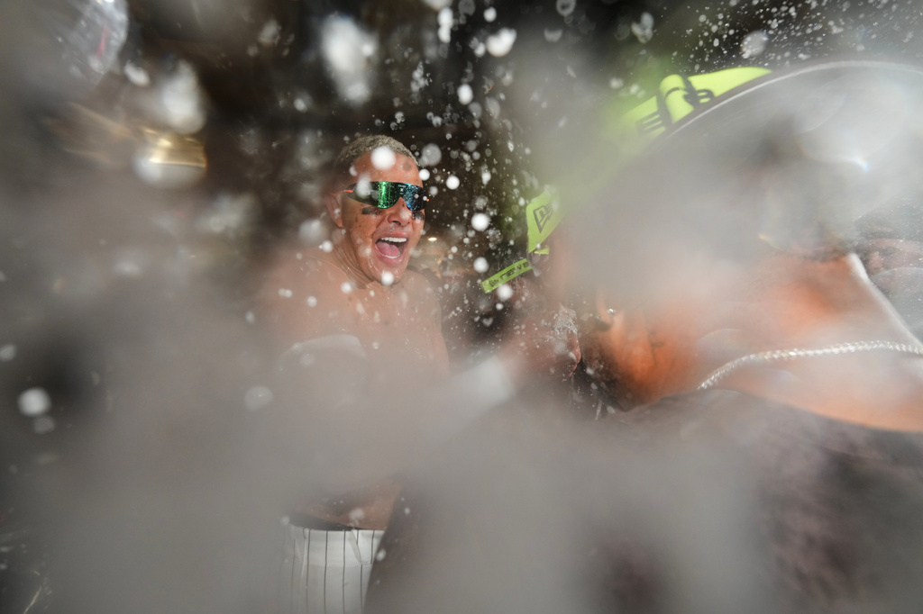 The New York Yankees take a group photo on the field to celebrate after winning baseball's American League Wild Card Series against the Boston Red Sox in Game 2, Wednesday, Sept. 30, 2026, in New York. (AP Photo/Yuki Iwamura)
