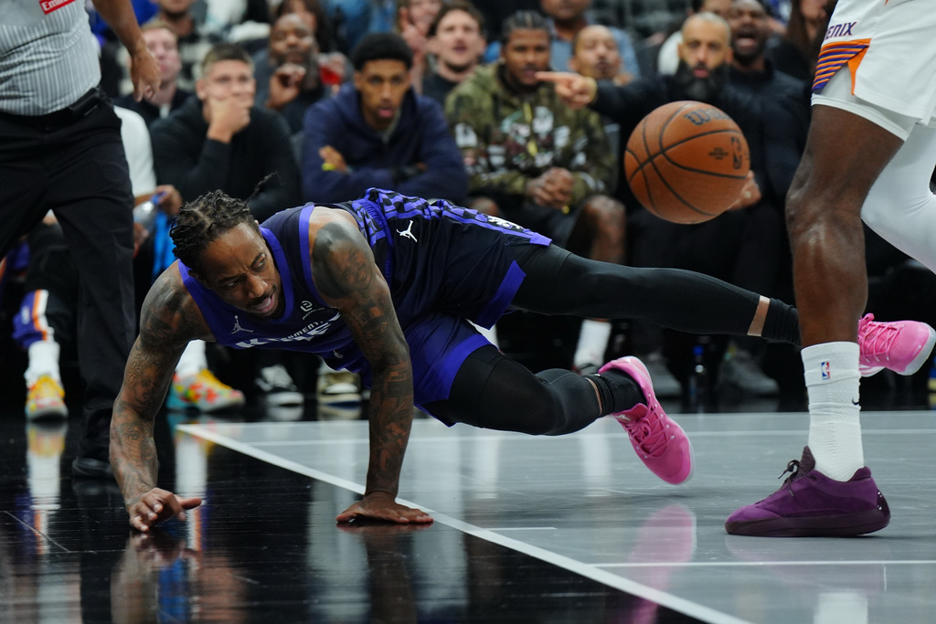 Sacramento Kings guard DeMar DeRozan saves the ball from going out of bounds against the Phoenix Suns during the first half of an Emirates NBA Cup basketball game, Wednesday, Nov. 26, 2025, in Sacramento, Calif. (AP Photo/Alan Greth)