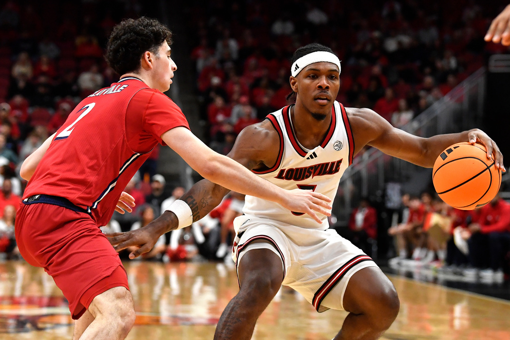 Louisville guard Ryan Conwell (3) attempts to get past NJIT guard Jeremy Clayville (2) during the second half of an NCAA college basketball game in Louisville, Ky., Wednesday, Nov. 26, 2025. (AP Photo/Timothy D. Easley)