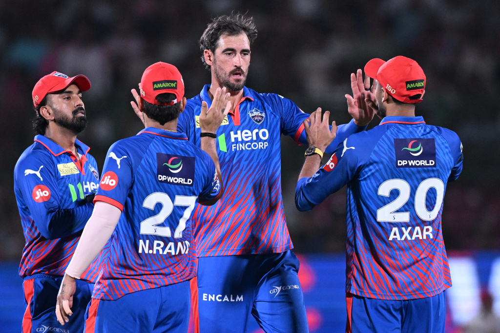 Delhi Capitals' Mitchell Starc celebrates the wicket of Rajasthan Royals' captain Riyan Parag with with teammates during the Indian Premier League cricket match between Delhi Capitals and Rajasthan Royals in Jaipur, India, Friday,May, 1, 2026. (AP Photo)