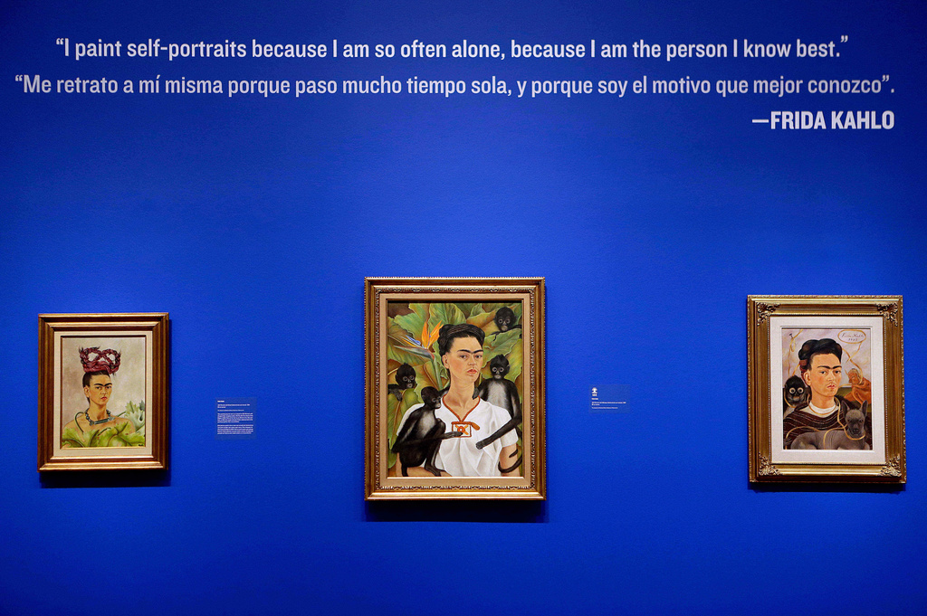 FILE - Self portraits by artist Frida Kahlo, titled from left, "Self Portrait with Braids", 1941, "Self Portrait with Monkeys", 1943, and "Self Portrait with Small Monkey", 1945, are displayed as part of the exhibition "Frida & Diego: Passion Politics and Painting", at the High Museum in Atlanta, Feb. 8, 2013. (AP Photo/David Goldman, File)
