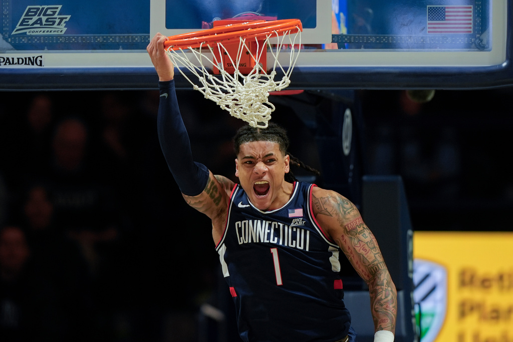 UConn guard Solo Ball reacts after dunking the ball during the first half of an NCAA college basketball game against Xavier, Wednesday, Dec. 31, 2025, in Cincinnati. (AP Photo/Carolyn Kaster)