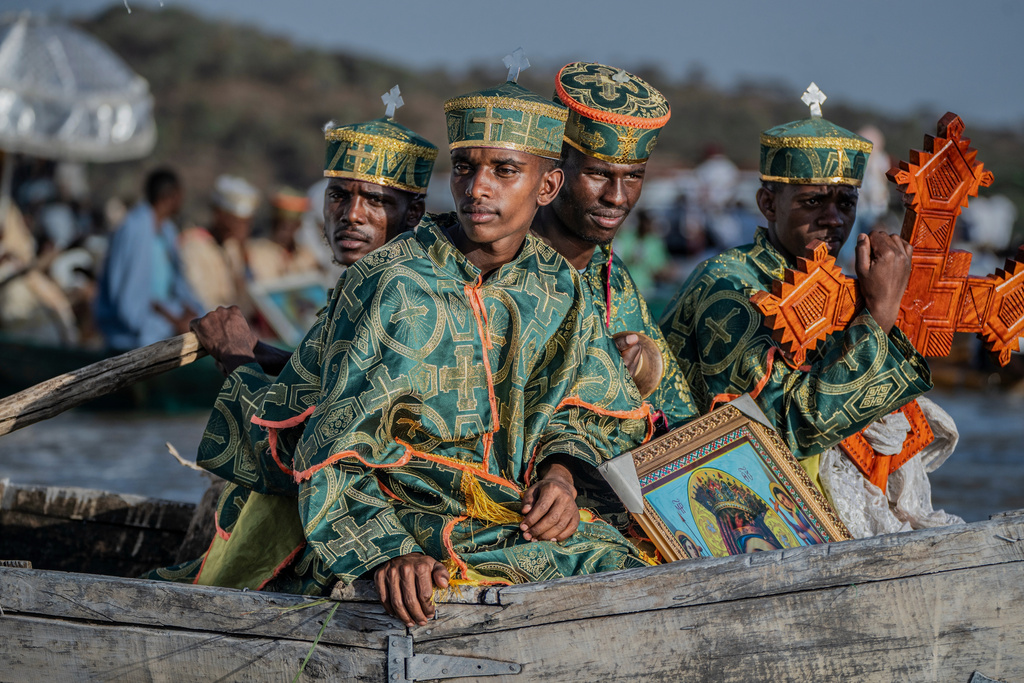 High priests ride in a boat as faithful celebrate Timket, the Ethiopian Epiphany, on lake Dembel, in Batu, Ethiopia, Sunday, Jan. 18, 2026. (AP Photo/Amanuel Sileshi)