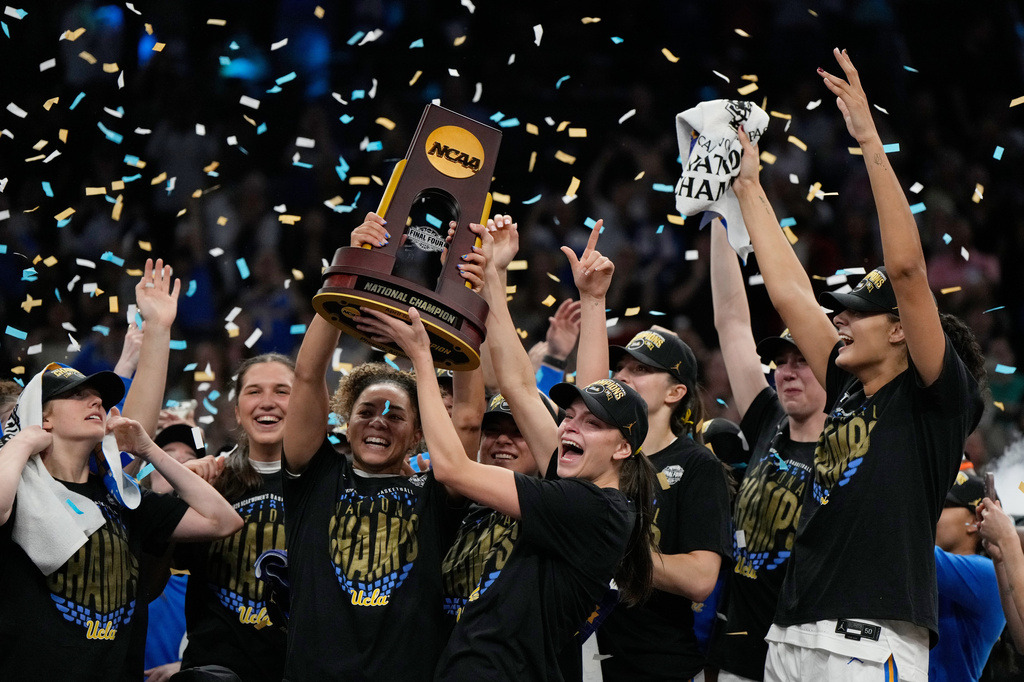 UCLA players celebrate after defeating South Carolina in the women's National Championship Final Four NCAA college basketball tournament game, Sunday, April 5, 2026, in Phoenix. (AP Photo/Ross D. Franklin)