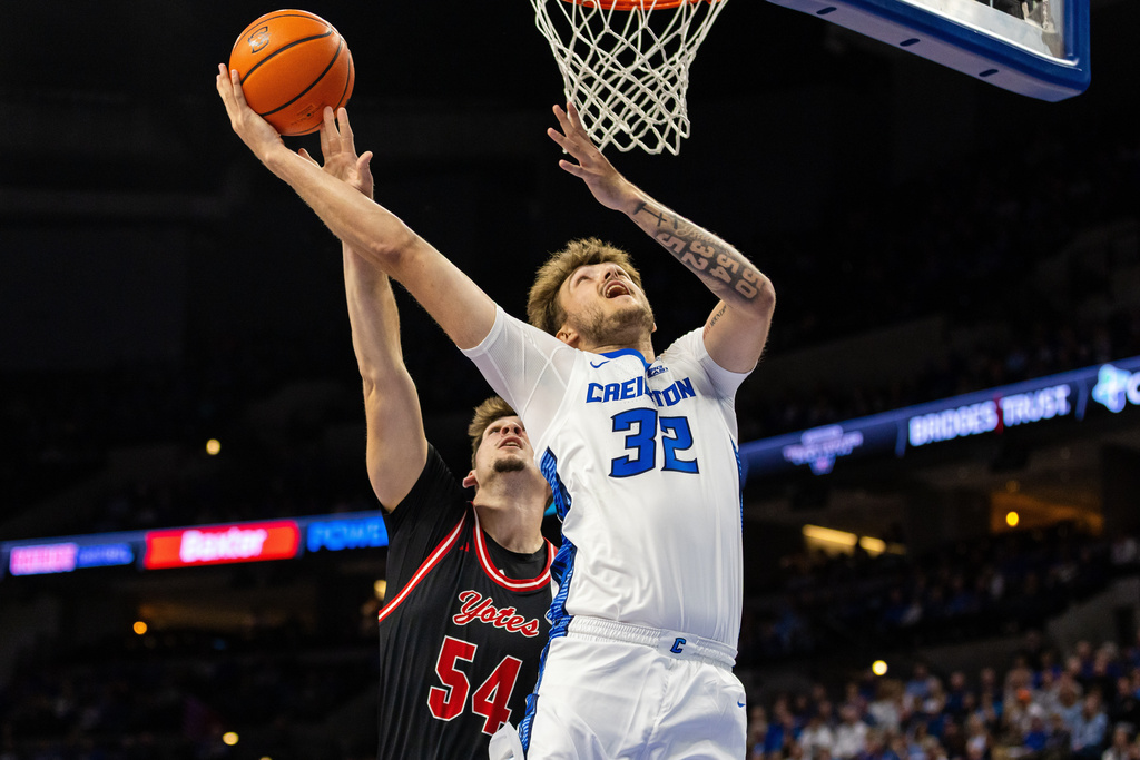Creighton forward Owen Freeman (32) goes up for a layup against South Dakota center Cameron Fens (54) during the first half of an NCAA college basketball game, Wednesday, Nov. 5, 2025, in Omaha, Neb. (AP Photo/Bonnie Ryan)