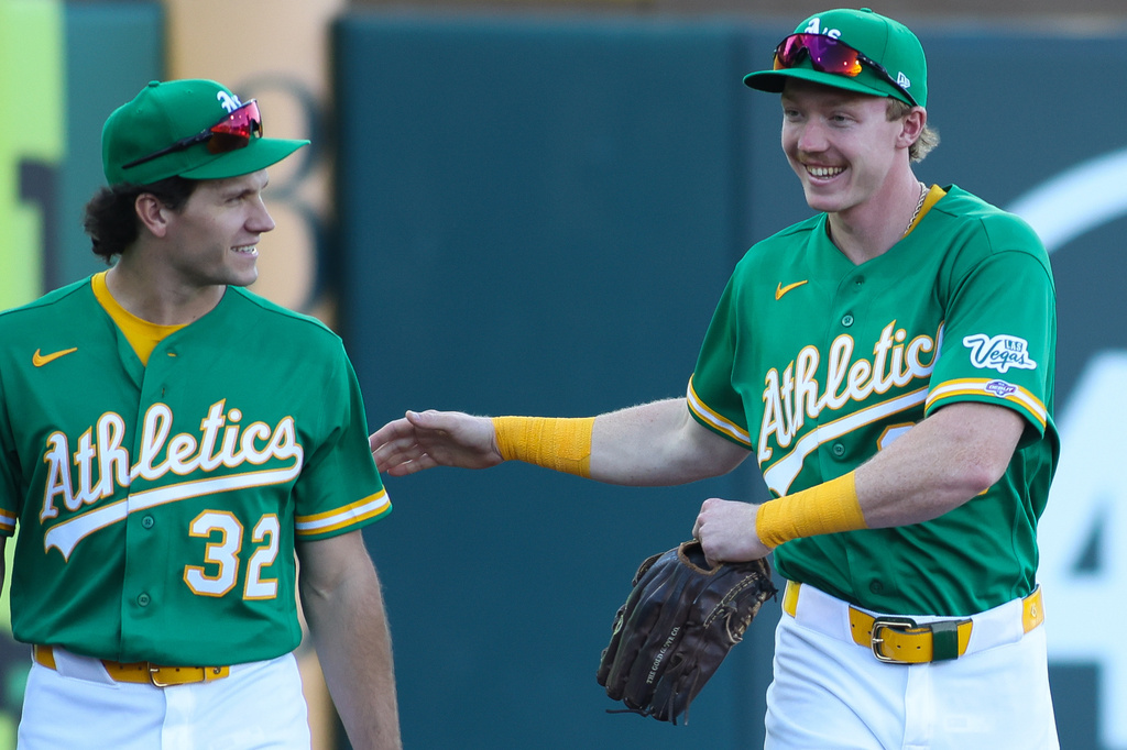 Athletics' Henry Bolte, right, talks with Colby Thomas before making his MLB debut before a baseball game against the St. Louis Cardinals, Wednesday, May 13, 2026, in West Sacramento, Calif. (AP Photo/Scott Marshall)