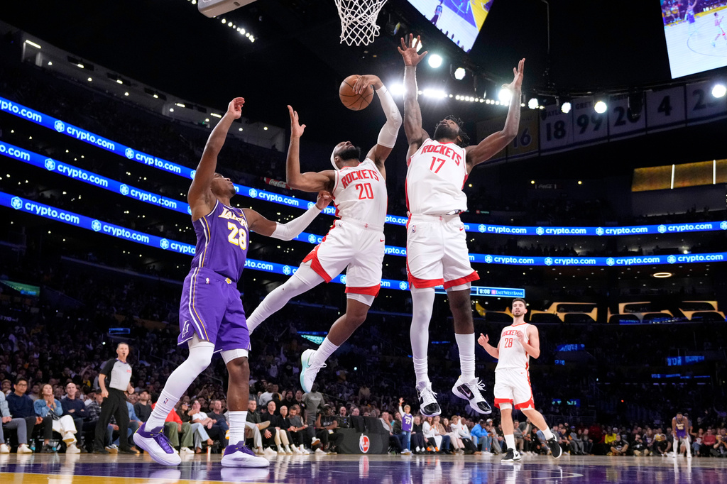Houston Rockets guard Josh Okogie, center, grabs a rebound away from Los Angeles Lakers forward Rui Hachimura, left, as forward Tari Eason also reaches during the first half in Game 5 of a first-round NBA playoffs basketball series Wednesday, April 29, 2026, in Los Angeles. (AP Photo/Mark J. Terrill)