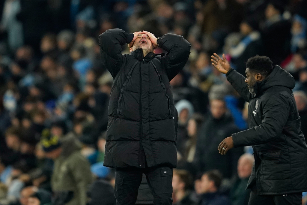 Manchester City's head coach Pep Guardiola, center, reacts after Chelsea's Enzo Fernandez scoring during the English Premier League soccer match between Manchester City and Chelsea in Manchester, England, Sunday, Jan. 4, 2026. (AP Photo/Dave Thompson)