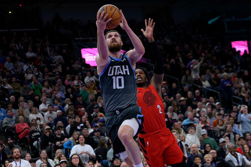 Utah Jazz guard Svi Mykhailiuk (10) goes to the basket for a layup guarded by Portland Trail Blazers guard Caleb Love (2) during the second half of an NBA basketball game, Thursday, Feb. 12, 2026, in Salt Lake City. (AP Photo/Tyler Tate)