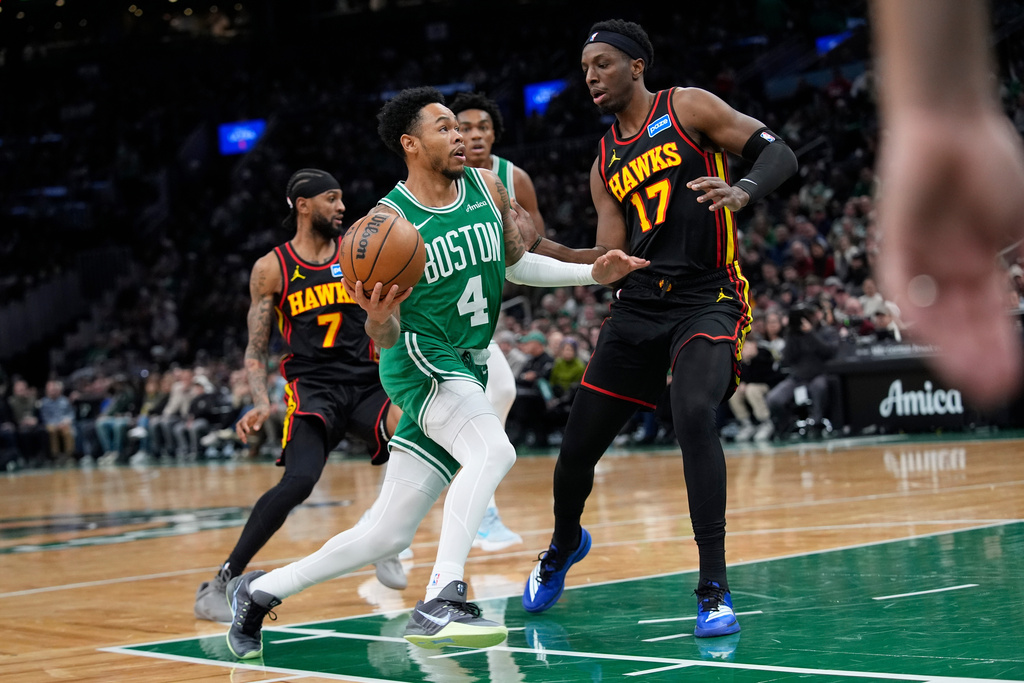 Boston Celtics guard Anfernee Simons (4) gores up for a layup against Atlanta Hawks forward Onyeka Okongwu (17) during the first half of an NBA basketball game Wednesday, Jan. 28, 2026, in Boston. (AP Photo/Robert F. Bukaty)