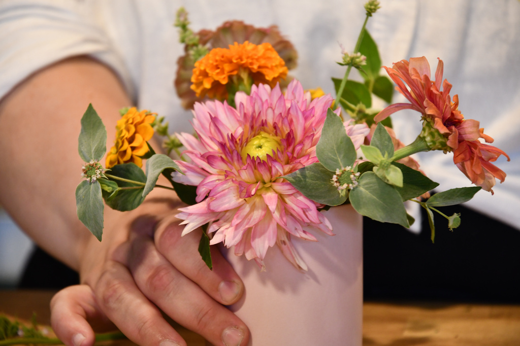 Marisa Mender-Franklin holds a bouquet of flowers on Thursday, July 23, 2026, in her florist shop, Midtown Bramble & Bloom, in Memphis, Tenn. (AP Photo/Kristin M. Hall)
