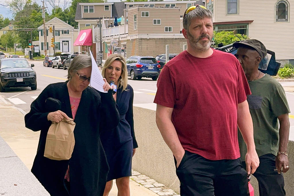 FILE - Denise Lodge, left, covers her face with a printout of the indictment against her as she walks from the federal courthouse, June 14, 2023, in Concord, N.H., following her arrest on charges related to an alleged scheme to steal and sell donated body parts. (Steven Porter/The Boston Globe via AP, File)