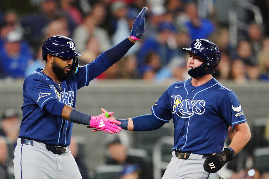 Tampa Bay Rays' Junior Caminero (left) and Ben Williamson (15) celebrate after scoring against the Toronto Blue Jays during third inning of a baseball game in Toronto on Tuesday, May 12, 2026. (Frank Gunn/The Canadian Press via AP)