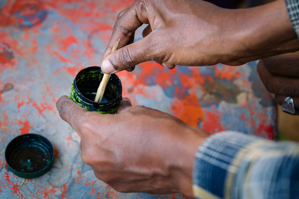 Dahir Yousef Abdi, guide from the Somali Region Pastoral and Agro-pastoral Research Institute, demonstrates ink made from myrrh Friday, Jan. 9, 2026, in Sanqotor, Ethiopia. Myrrh, in Islam tradition, is turned into a black ink used only for writing the Quran and symbolizes the connection between the word and the divine. (AP Photo/Julianne Gauron)
