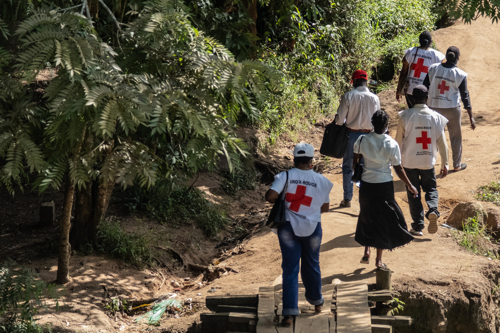 Red Cross volunteers on an outreach to speak to people during a public sensitisation campaign amid the Ebola outbreak in Bunia, Congo, Sunday, May 25, 2025. (AP Photo/Moses Sawasawa)