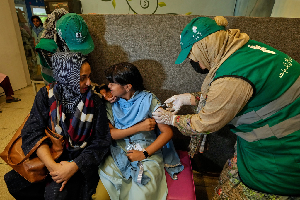 A health worker gives an injection of human papillomavirus (HPV) vaccine to a girl during a campaign aiming to protect girls from cervical cancer, at a vaccination center, Karachi, Pakistan, Friday, Sept. 26, 2025. (AP Photo/Fareed Khan)