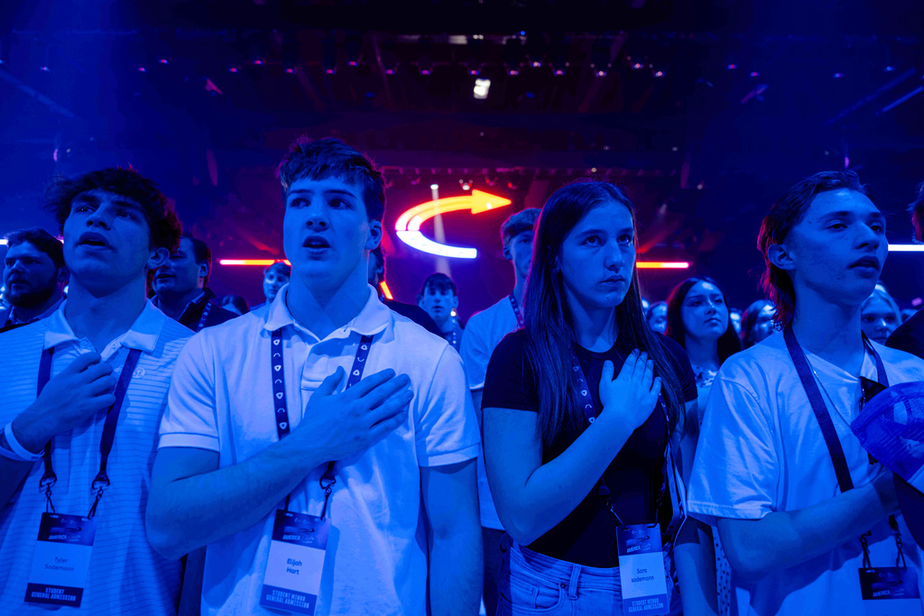 Attendees stand during Turning Point USA's AmericaFest 2025, Thursday, Dec. 18, 2025, in Phoenix. (AP Photo/Jon Cherry)