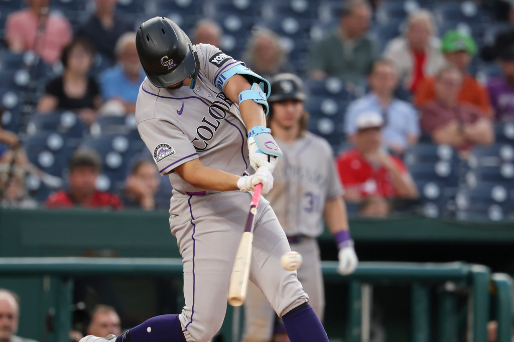 Colorado Rockies' Ezequiel Tovar hits a double off Washington Nationals pitcher Cade Cavalli during the third inning of a baseball game in Washington, Monday, Aug. 24, 2026. (AP Photo/Terrance Williams)