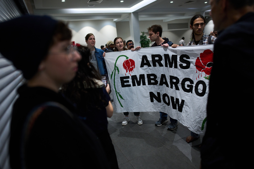 Activists protest against a defense industry exhibition in Tel Aviv, Israel, Tuesday, Feb. 17, 2026. (AP Photo/Oded Balilty)