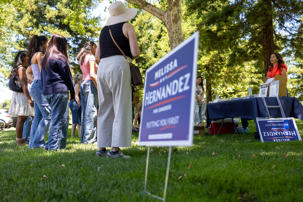 Melissa Hernandez, right, a Democratic candidate for Congress in California's 14th district, talks to campaign volunteers during a canvassing event on Sunday, June 14, 2026, in Pleasanton, Calif. (AP Photo/Annie Barker )