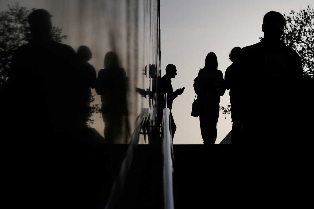People enter an underpass during sunset in Moscow, Thursday, March 12, 2026. (AP Photo/Pavel Bednyakov)