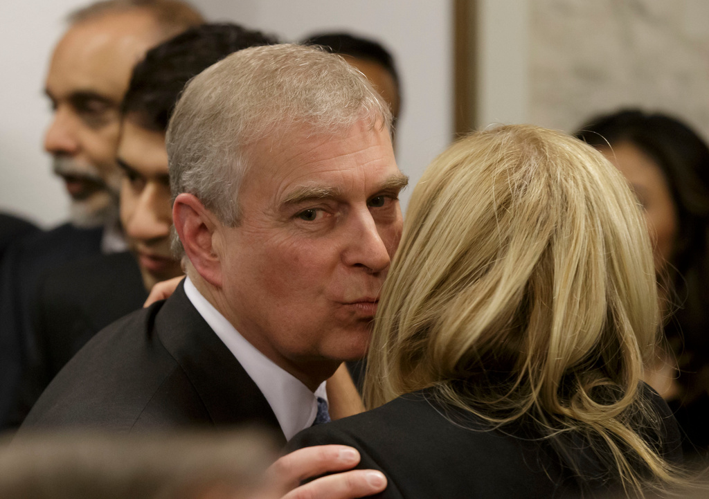 FILE - Britain's Prince Andrew, greets a business leader during a reception at the sideline of the World Economic Forum in Davos, Thursday, Jan. 22, 2015. (AP Photo/Michel Euler, Pool, File)