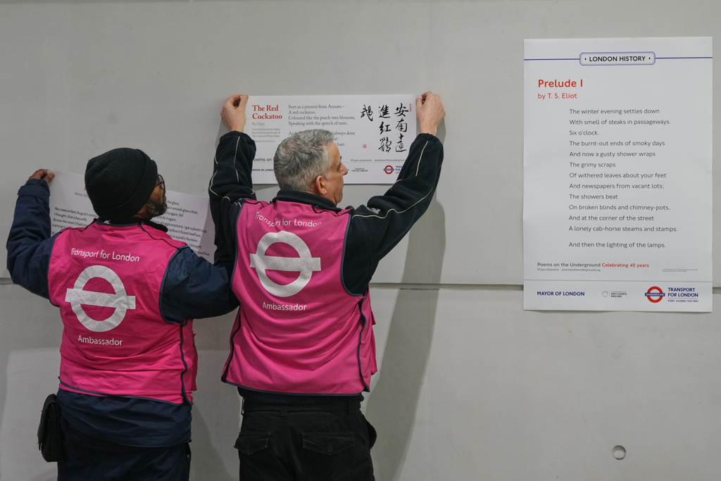 TFL ambassadors display poems for a gathering to celebrate 40 years of 'Poems on the Underground' in London, Friday, Jan. 30, 2026. (AP Photo/Kirsty Wigglesworth)